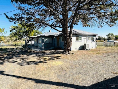 View of home's exterior featuring a metal roof, crawl space, and a gate