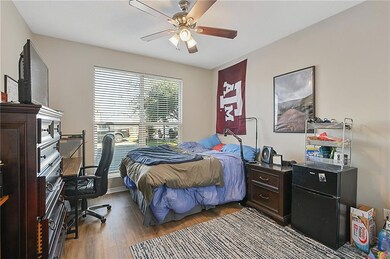 Bedroom with wood finished floors and a ceiling fa