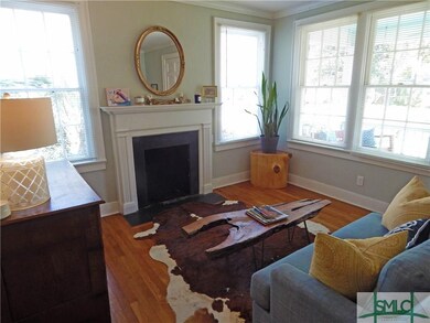 The living room with decorative fireplace has orig