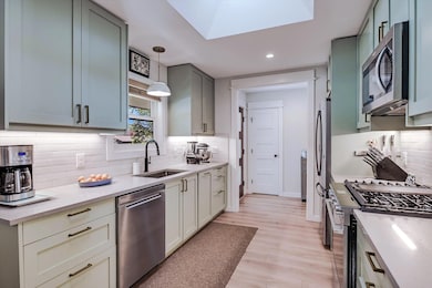 Kitchen with stainless steel appliances, light co