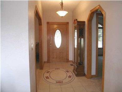 A view of the foyer with the tile floor and custom