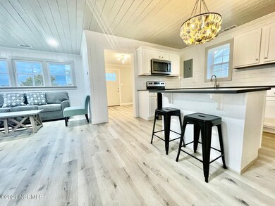 KITCHEN AND LIVING ROOM LOOKING TO FOYER