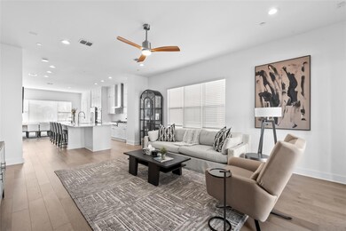 Living area with recessed lighting, ceiling fan, light wood-style flooring, and plenty of natural light