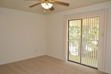 Empty room featuring baseboards, a ceiling fan, an