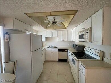 Kitchen featuring white appliances, white cabinets