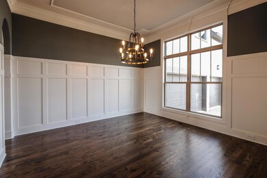 Nicely detailed dining room with wainscoting.