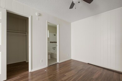 Unfurnished bedroom with a closet, a textured cei
