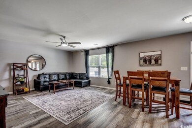 Living room featuring a ceiling fan and wood finished floors