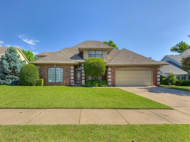 View of front facade with an attached garage, brick siding, a front lawn, concrete driveway, and roof with shingles