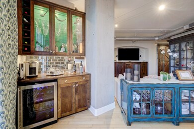 The beverage bar features beautiful glass front ca