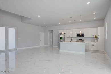 Kitchen featuring french doors, a center island wi
