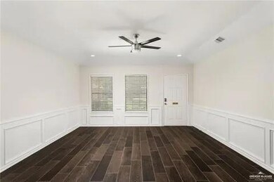 Spare room with ceiling fan, wood finished floors, wainscoting, recessed lighting, and a decorative wall