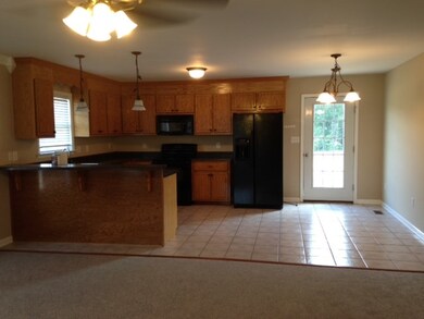 KITCHEN WITH DINING AREA AND GLASS DOOR OPENING TO