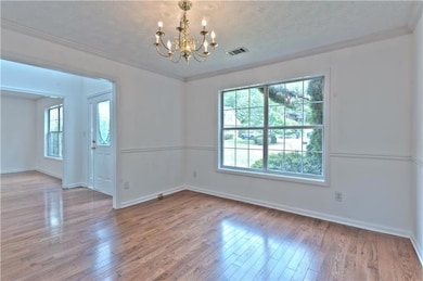 Unfurnished room featuring an inviting chandelier,