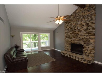 Family room with beautiful stone fireplace.