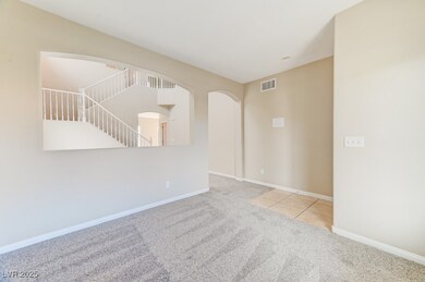 Carpeted empty room with arched walkways and baseb