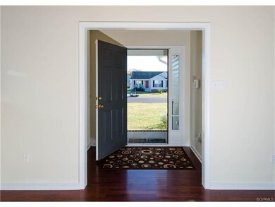 The foyer has hardwood flooring, entry door with s