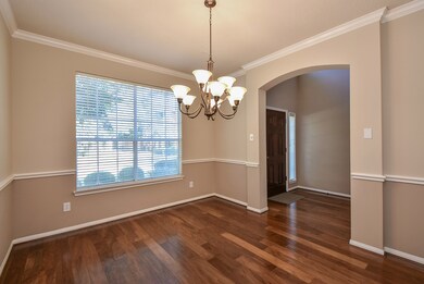 Formal dining room off of entry with crown molding, chair rail & hand scraped walnut wood floors.  Need a home office?  No problem!  This space can easily be converted by adding double doors.