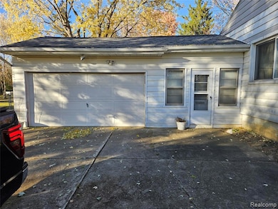 Garage featuring concrete driveway