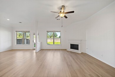 The large family room features high ceilings and gas fireplace. Gather with friends and family here.