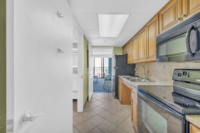 Kitchen featuring a sink, light countertops, decor