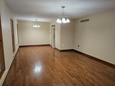Unfurnished room with a textured ceiling, a notabl
