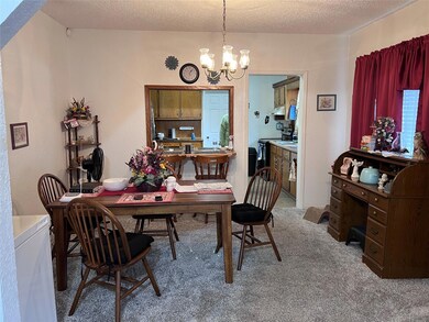 Dining space featuring a textured ceiling, an invi