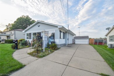View of front of house with a garage, a front yard, and central​​‌​​​​‌​​‌‌​​​‌​​‌‌​​‌‌​‌​​​‌‌​​‌​​​​​‌ AC