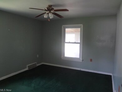 Bedroom first floor carpeted with ceiling fan