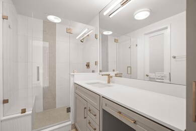 Bathroom featuring vanity and a stall shower