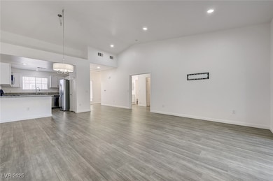 Unfurnished living room featuring light wood-style