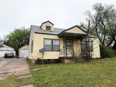 View of front of home with a garage and a front la