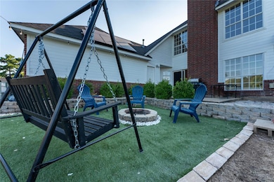 View of community featuring a fire pit, a yard, an
