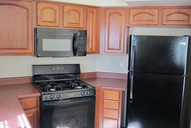 Cherry Cabinets and Black appliances
