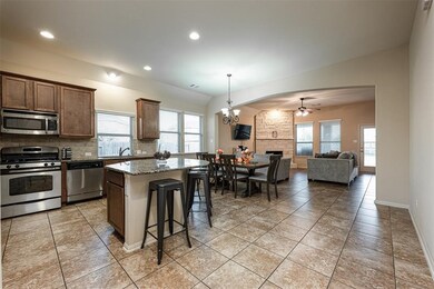 Look how perfect this kitchen is for entertaining! You can prepare delicious meal for everyone while having some good conversation together! There is plenty of counter space and room for storage in this amazing kitchen! Beautiful wooden cabinets, granite countertops, SS appliances, recessed lighting, and an island/breakfast bar!