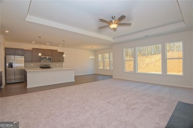 Unfurnished living room with ceiling fan with nota