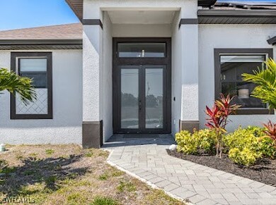 View of exterior entry featuring stucco siding