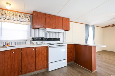 Kitchen featuring hardwood / wood-style floors, si