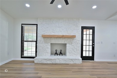 Unfurnished living room featuring wood finished fl