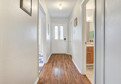 Entryway featuring light wood-style flooring, bas