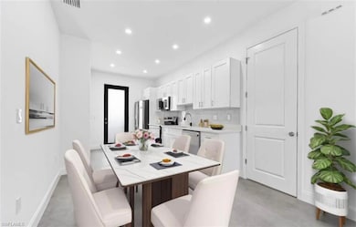 Dining room with recessed lighting and baseboards
