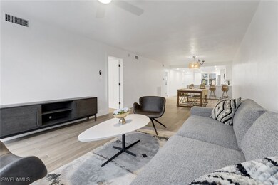 Living area, visible vents, ceiling fan, and 6