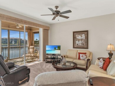 Carpeted living room featuring a ceiling fan