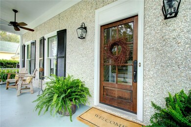 Welcoming front porch, tabby exterior.