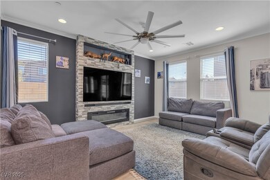 Living room featuring crown molding, a healthy amo