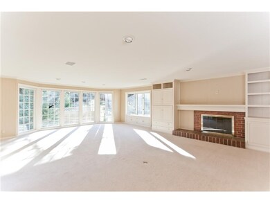 Living room area with large floor to ceiling windo