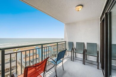 Balcony with view of water and beach