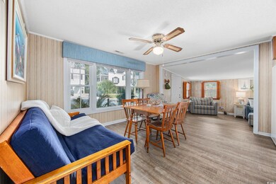 Dining area with wood walls, ceiling fan, wood-typ