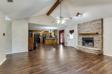 Unfurnished living room with ceiling fan, a stone 