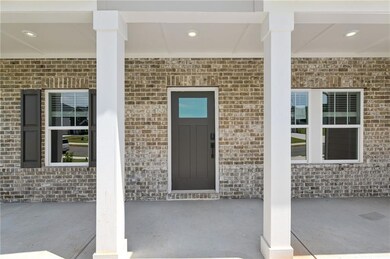 View of exterior entry featuring brick siding